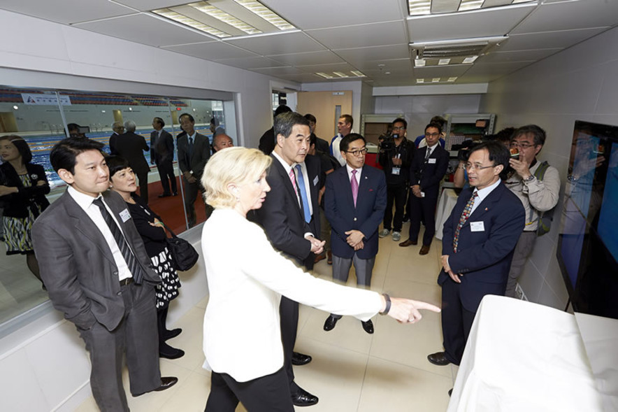 Dr Trisha Leahy, Chief Executive of the HKSI introduces to the Honourable CY Leung, the Chief Executive of HKSAR, how the under-water observation windows of the new 52m swimming pool in operation with a video analysis system for sport science to enhance athlete’s performance.